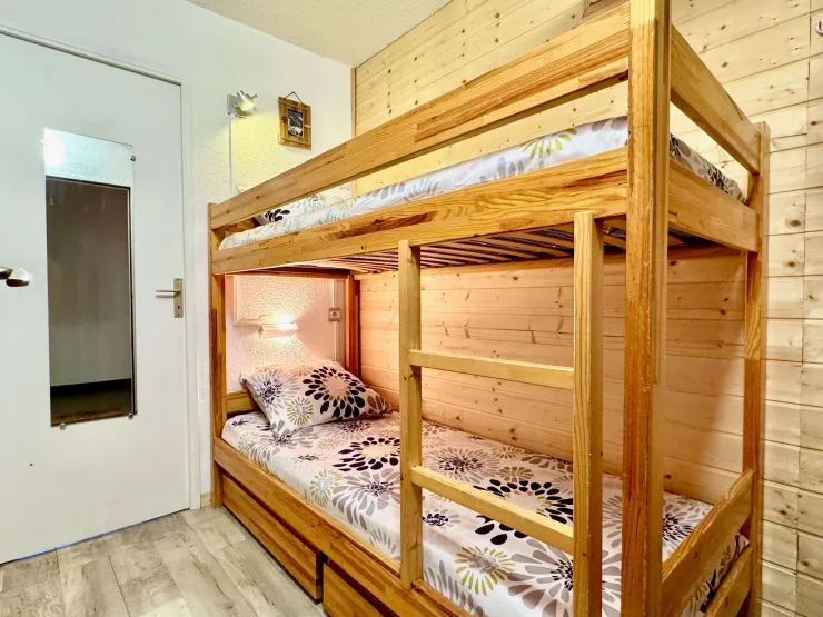 Enclosed sleeping area with bunk beds and drawers for storage