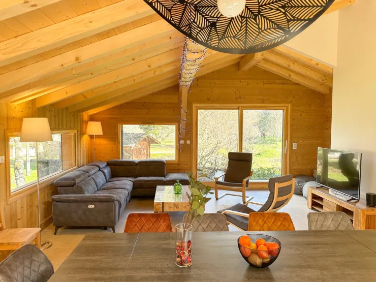 Large, bright living room opening onto the outside.
