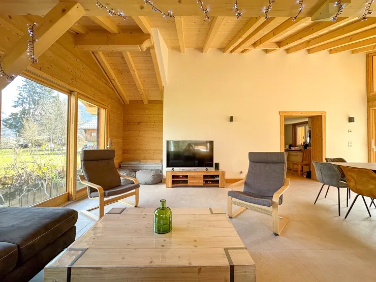Large, bright living room opening onto the outside.