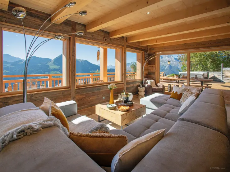 Alpine elegance at its finest: a spacious, sun-lit living room with exceptional mountain views. The heart of the chalet, designed for comfort and luxury.