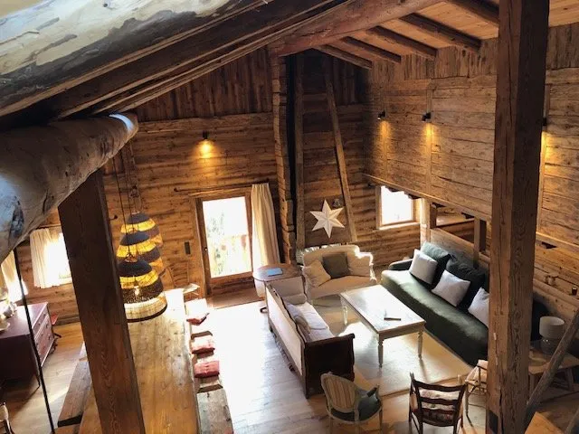VIEW OF THE LIVING ROOM AND DINING AREA LOCATED IN THE CONVERTED BARN