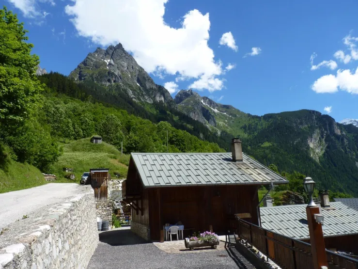 Entrance of the chalet and its private car park in summer