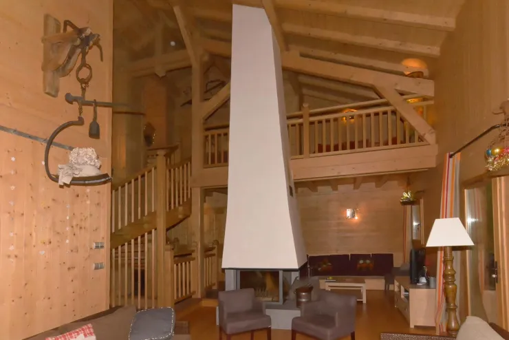 Level 2. Overview of the living room, TV sitting-room, central fireplace (glazed on 4 faces) , mezzanine, and the stairs (to the bedrooms upward and to the studio downward).