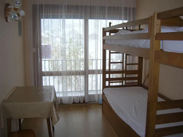 Chambre donnant sur un balcon. 2 fois 2 lits superposés. Grand placard de rangement et penderie. 2 grands tiroirs sous les lits.