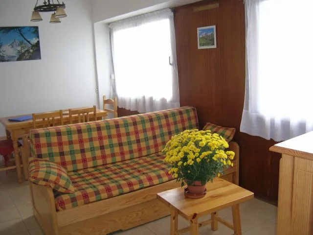 Living room south facing, overlooking a terrace and a lawn.