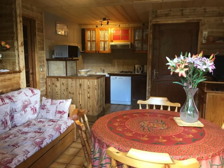 Salle avec divan gigogne et cuisine 